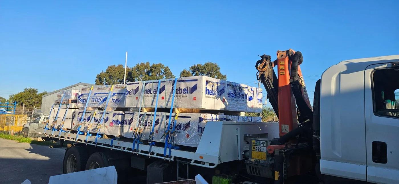 Flatbed truck loaded with Hebel building panels ready for delivery.