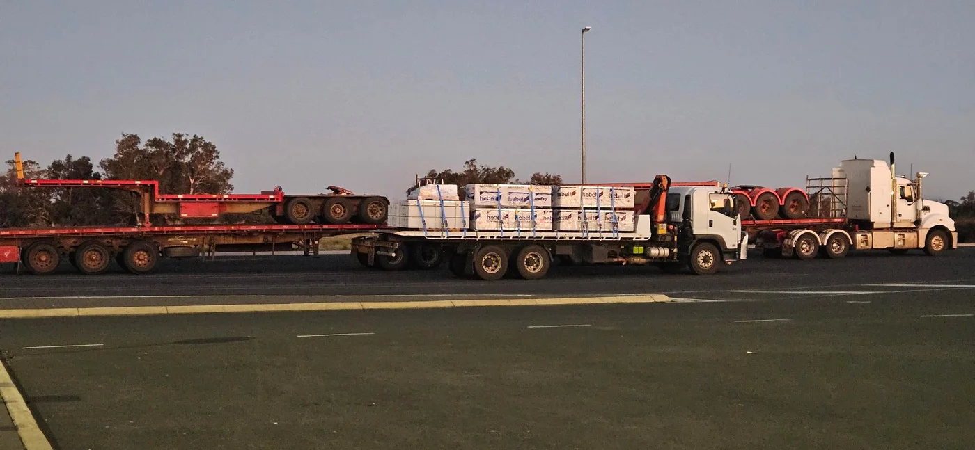 Lane Transport fleet lined up at dawn with Hebel panels on the hiab truck.