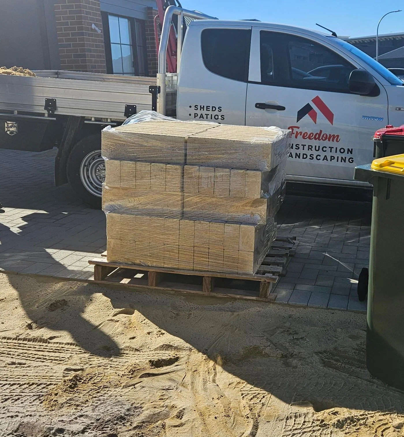 Pallet of landscaping blocks delivered on a flatbed trailer.