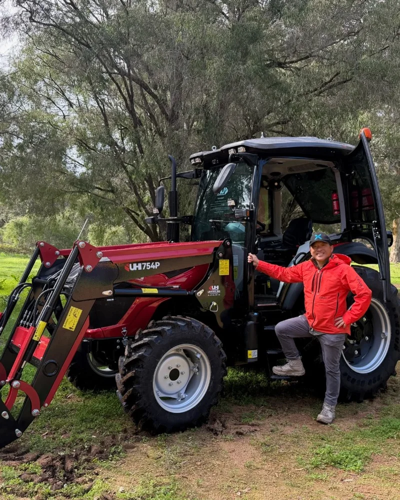 DeKai standing with a red UH754P tractor after a South West delivery